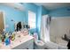 Charming bathroom with a vibrant blue color scheme, functional shower and toilet at 6614 Wicked Oak Ln, Charlotte, NC 28216