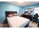 Bedroom showcasing blue walls, a bed, dresser, and window at 6614 Wicked Oak Ln, Charlotte, NC 28216
