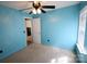Cozy bedroom showcases blue walls, neutral carpet, a window, and a ceiling fan at 6614 Wicked Oak Ln, Charlotte, NC 28216