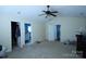 Bright bedroom with a ceiling fan and access to multiple bathrooms and closet at 6614 Wicked Oak Ln, Charlotte, NC 28216