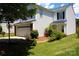 Charming two-story home with a well-kept lawn, featuring an attached garage and inviting front porch at 6614 Wicked Oak Ln, Charlotte, NC 28216