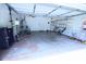 Spacious two car garage with fans, shelving, and storage for tools and equipment at 6614 Wicked Oak Ln, Charlotte, NC 28216