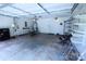 Spacious two car garage with fans, shelving, and storage for tools and equipment at 6614 Wicked Oak Ln, Charlotte, NC 28216