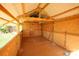 Unfinished interior features wood framing, partial walls, tile floor and an open roof with metal sheeting at 6614 Wicked Oak Ln, Charlotte, NC 28216