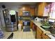 Spacious kitchen with wood cabinets, stainless steel refrigerator and granite countertops great for cooking at 6614 Wicked Oak Ln, Charlotte, NC 28216