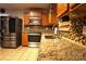 Modern kitchen with stainless steel appliances, granite counters, and mosaic tile backsplash at 6614 Wicked Oak Ln, Charlotte, NC 28216