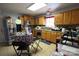 Functional kitchen featuring wood cabinets, stainless steel refrigerator and appliances perfect for culinary endeavors at 6614 Wicked Oak Ln, Charlotte, NC 28216