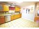 Kitchen view shows a bright space with wood cabinets and a convenient breakfast bar at 6614 Wicked Oak Ln, Charlotte, NC 28216
