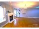 Bright living room with hardwood floors and a cozy fireplace, perfect for relaxing at 6614 Wicked Oak Ln, Charlotte, NC 28216