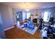 Cozy living room featuring hardwood floors, fireplace, and ample natural light perfect for entertaining or relaxation at 6614 Wicked Oak Ln, Charlotte, NC 28216