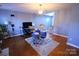Bright living room featuring hardwood floors, fireplace and modern lighting, offering a comfortable and stylish space at 6614 Wicked Oak Ln, Charlotte, NC 28216