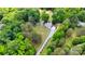Aerial view of a property featuring a home, outbuilding, and lush surrounding trees at 6910 Birdsong Ln, Waxhaw, NC 28173