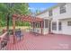 Expansive wooden deck with pergola, seating, and screened-in porch for outdoor enjoyment at 6910 Birdsong Ln, Waxhaw, NC 28173