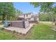 Beautiful backyard features hot tub, wooden deck and landscaped stone paver patio at 6910 Birdsong Ln, Waxhaw, NC 28173