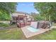 Backyard features hot tub, wooden deck, and patio with pavers at 6910 Birdsong Ln, Waxhaw, NC 28173