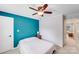 This bedroom features a striking turquoise accent wall, complemented by neutral tones for a modern feel at 6910 Birdsong Ln, Waxhaw, NC 28173