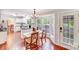 Bright breakfast nook with wood floors, natural light, and a view to the outdoor living space at 6910 Birdsong Ln, Waxhaw, NC 28173