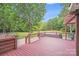 Relaxing deck featuring a hot tub and wooded backyard views at 6910 Birdsong Ln, Waxhaw, NC 28173