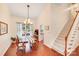 Dining room with tall ceilings, hardwood floors, chandelier, and access to the kitchen at 6910 Birdsong Ln, Waxhaw, NC 28173