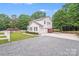 Charming exterior view of a white two-story home with a two-car garage and manicured landscaping at 6910 Birdsong Ln, Waxhaw, NC 28173