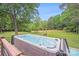 Hot tub sits on a stone paver platform in the backyard at 6910 Birdsong Ln, Waxhaw, NC 28173
