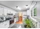 Modern kitchen with white cabinets, granite countertops, and stainless steel appliances at 6910 Birdsong Ln, Waxhaw, NC 28173