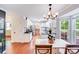 Open kitchen with granite countertops, white cabinets, hardwood floors, and stainless steel appliances at 6910 Birdsong Ln, Waxhaw, NC 28173