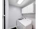 Functional laundry room with washer, dryer, and storage cabinets at 6910 Birdsong Ln, Waxhaw, NC 28173