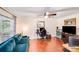 Cozy living room featuring wood floors, a ceiling fan, and a comfortable sofa at 6910 Birdsong Ln, Waxhaw, NC 28173
