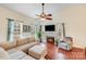 Cozy living room with a fireplace, hardwood floors, and a comfortable sectional sofa at 6910 Birdsong Ln, Waxhaw, NC 28173