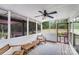 Relax on this charming screened porch with its cozy seating, ceiling fan, and serene outdoor views at 6910 Birdsong Ln, Waxhaw, NC 28173