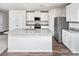 Modern kitchen with white cabinets, stainless steel appliances, and a granite-topped center island at 7023 Jerimoth Dr, Charlotte, NC 28215