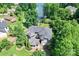 Stunning aerial view of home with mature landscaping and a tranquil lake in the background at 7365 Gabriel St, Sherrills Ford, NC 28673