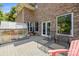 View of large back deck with lounging furniture, grill, and adjacent greenhouse; perfect for relaxing outside at 7365 Gabriel St, Sherrills Ford, NC 28673