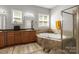Bathroom with neutral countertops, cabinetry, a soaking tub, and walk-in shower at 7365 Gabriel St, Sherrills Ford, NC 28673