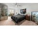 Comfortable bedroom with ceiling fan, neutral carpet, and collection displays at 7365 Gabriel St, Sherrills Ford, NC 28673
