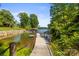 A picturesque waterfront view features a private dock, mature trees, and a glimpse of the serene lake at 7365 Gabriel St, Sherrills Ford, NC 28673