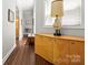 Hallway with hardwood floors, neutral walls, wooden accent furniture, and natural light from the window at 7365 Gabriel St, Sherrills Ford, NC 28673