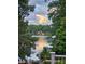 Picturesque lake view showcasing lush greenery and serene waterfront living, framed by foliage at 7365 Gabriel St, Sherrills Ford, NC 28673