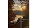 Scenic lake view at sunset framed by fall foliage, showcasing waterfront living and natural beauty at 7365 Gabriel St, Sherrills Ford, NC 28673
