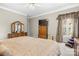 Spacious main bedroom with carpet, neutral walls, wood furniture, and natural light from the window at 7365 Gabriel St, Sherrills Ford, NC 28673