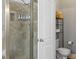Shower stall with tile walls and door; next to a toilet with storage and shelving behind at 7365 Gabriel St, Sherrills Ford, NC 28673