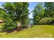A lush waterfront view features a private dock, mature trees, and a glimpse of the serene lake at 7365 Gabriel St, Sherrills Ford, NC 28673