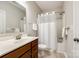 Well-lit bathroom with a shower-tub combo, a classic vanity with a sink, and a white shower curtain at 801 Hidden Pond Ln, Waxhaw, NC 28173