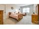 Charming bedroom featuring twin beds with decorative pillows, wooden furniture, and a bright window for natural light at 801 Hidden Pond Ln, Waxhaw, NC 28173