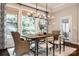 An elegant dining room showcases a rustic wood table and plush seating, perfect for Gathering gatherings and dinner parties at 801 Hidden Pond Ln, Waxhaw, NC 28173