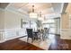 Elegant dining room with coffered ceilings, modern lighting, and a large table for entertaining at 801 Hidden Pond Ln, Waxhaw, NC 28173