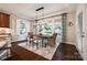 This dining area features ample natural light and provides a cozy ambiance with dark floors at 801 Hidden Pond Ln, Waxhaw, NC 28173