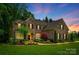 Beautiful two-story brick home with manicured landscaping and a warm, inviting entryway at 801 Hidden Pond Ln, Waxhaw, NC 28173