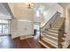 Grand foyer with hardwood floors, a staircase with iron railings, and a view into the living area at 801 Hidden Pond Ln, Waxhaw, NC 28173